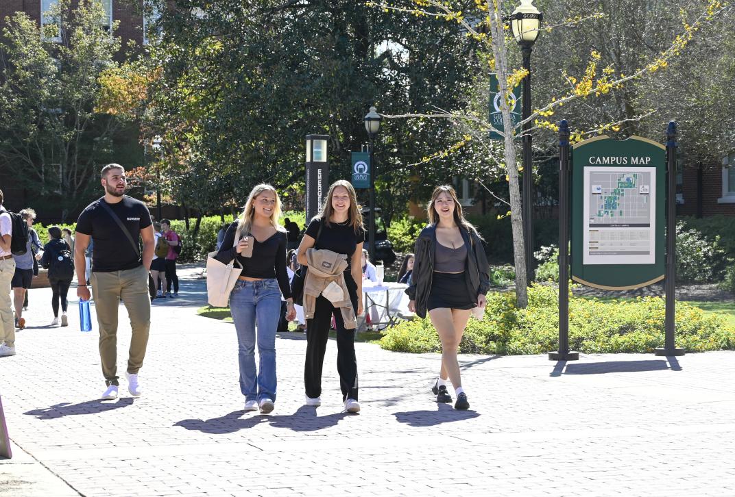 Students walk on the sidewalk at Georgia College