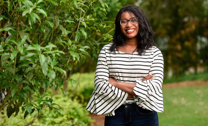 student posing on campus