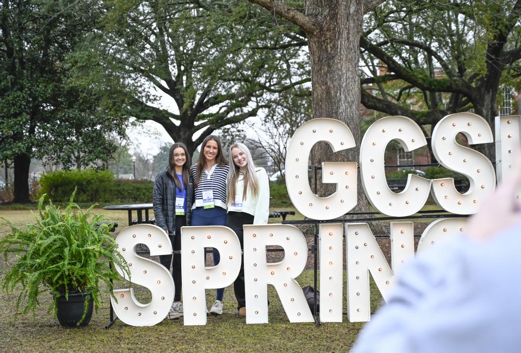 Students pose for a photo at the SpringFest sign