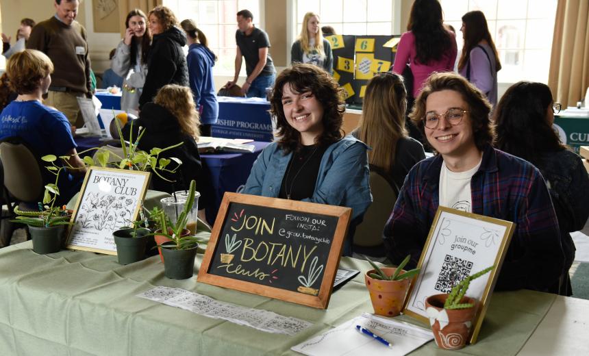 Botany club members smile for a photo at their booth